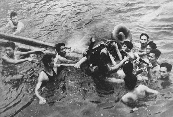 Airman being captured by Vietnamese civilians in Truc Bach Lake in 1967. The airman is John McCain