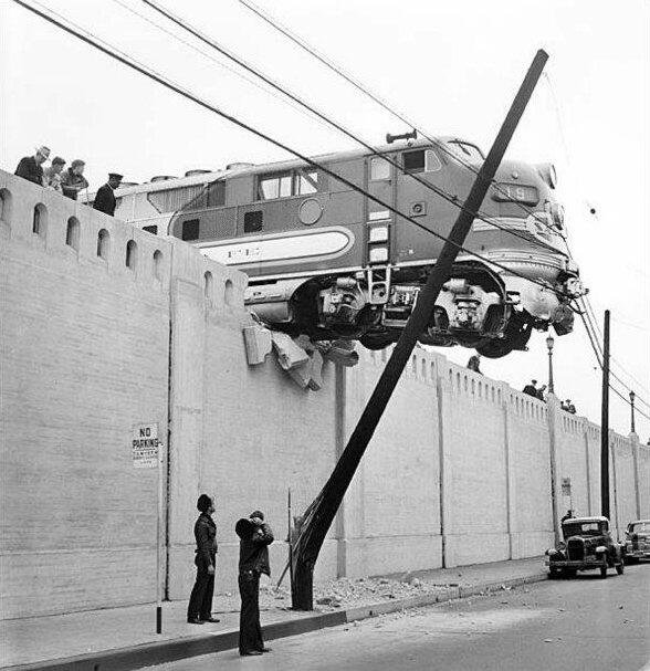 A locomotive hangs over Aliso Street after running off the end of rails at Union Station. LA, 1948 