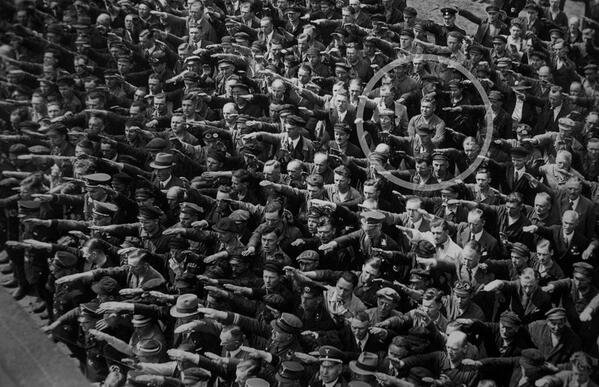 August Landmesser, a German who was engaged to a Jewish woman, refused to do the Nazi salute. Hamburg, 1936