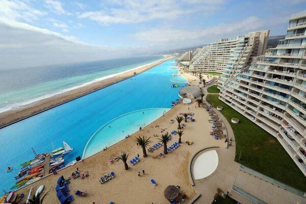 The worlds largest pool covers 20 acres, holds 66 million gallons of water and has a 115 foot deep e